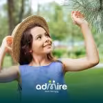 Smiling autistic girl holds toy with therapist, symbolizing progress and positive outcomes of ABA therapy.