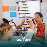 Autistic girl builds colorful structure with adult guidance, showing hands-on ABA therapy for behavior support.