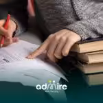 A therapist reviewing printed material and highlighting text, showing focus, comprehension, and academic learning strategies.