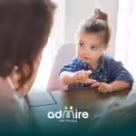 Autistic boy interacts with therapist during playtime, highlighting communication skills and verbal development.