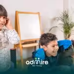 Autistic child covering ears during an indoor activity, illustrating sensory sensitivity & need for supportive environments.
