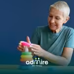 Autistic girl playing with a stacking toy, representing how autism traits can change over time after therapy