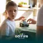 Therapist and autistic girl read together at a table, symbolizing long-term support, learning, and developmental growth.