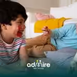  Autistic children participating in a guided group activity indoors, building social skills, listening, and cooperative play.