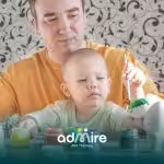 Therapist and autistic child paint together, symbolizing support, growth, and common questions on autism treatment.
