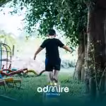 Autistic boy balancing on playground equipment, symbolizing diverse paths and abilities across the autism spectrum.
