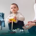 Autistic boy frames face with hands, illustrating repetitive movements commonly linked to autistic stimming.