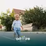 Autistic toddler walking alone on a quiet street, showing early childhood behaviors linked to autism signs.