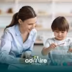 A therapist and autistic boy work together with colorful blocks, engaging in an educational activity with focus and enjoyment.
