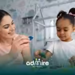 Therapist assisting autistic girl  with a shape sorting puzzle, supporting problem-solving, and coordination.