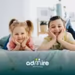 Two autistic kids lying on a bed at home, showing positive social bonding and relaxed interaction in a cozy environment