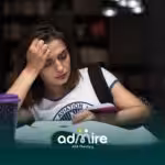 Tired ABA student studying late at a library desk with notebooks and coffee, struggling to stay focused.