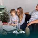 A family of three sitting in an office while a professional helps them with paperwork, creating a calm & welcoming atmosphere