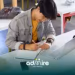 An ABA student writing notes beside laptop in classroom setting, illustrating use of study tools for preparing for the exam