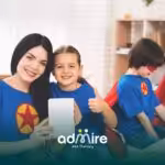 Therapist & autistic girl in superhero costumes smiling at camera, promoting confidence, bonding, and positive behavior