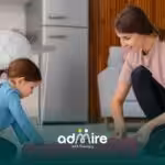 Therapist helping autistic kid roll out exercise mat at home, preparing environment for structured in-home ABA therapy