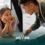 Father teaching autistic girl cooking skills in the kitchen while preparing food together at home with care