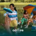 Autistic kid playing frisbee with friends at a park, enjoying an outdoor summer routine that encourages social play