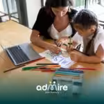 Therapist and autistic girl draw with colored pencils, building creativity, learning, and school readiness together.