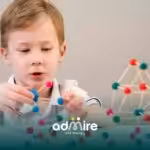 Autistic boy building colorful geometric structures with sticks and clay balls, developing problem-solving