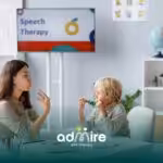 Speech therapist & autistic child practicing communication skills during an interactive speech therapy session in a clinic.