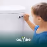 Autistic child practicing toilet training by reaching for a toilet flush handle, building bathroom independence skills.