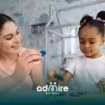 Therapist guiding an autistic child through a hands-on learning activity in a daycare-based ABA therapy setting