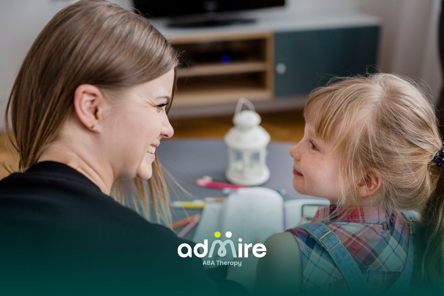 Smiling therapist and autistic girl make warm eye contact while reading together, encouraging communication during therapy