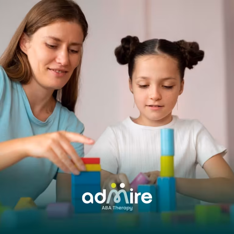 Female therapist guiding an autistic girl during therapy session, building colorful stacking blocks to support speech.