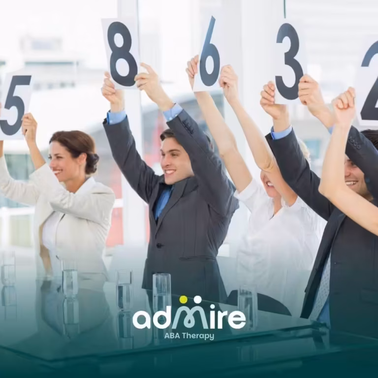 Therapist team holding up numbered score cards during a meeting, rating a presentation in a conference room.