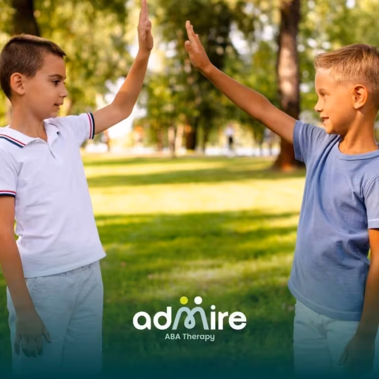 Two autistic boys high-fiving in a sunny park, showing friendship, social interaction, and childhood behavior.