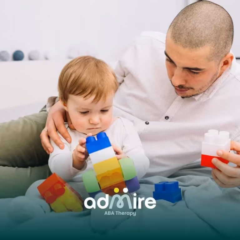 Autistic toddler plays with stacking toys as therapist supports, symbolizing early screening and autism evaluation.