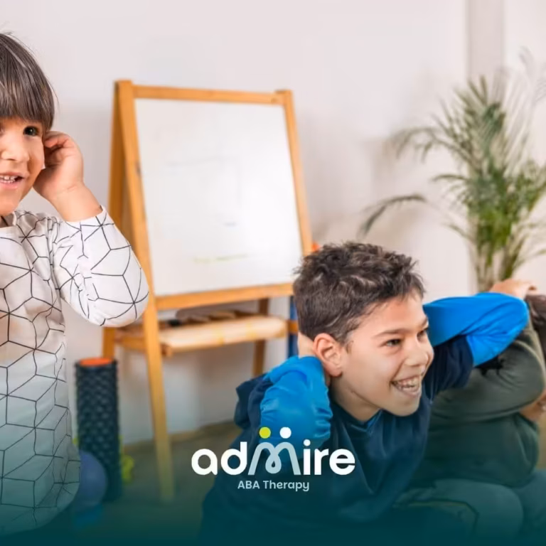 Autistic child covering ears during an indoor activity, illustrating sensory sensitivity & need for supportive environments.