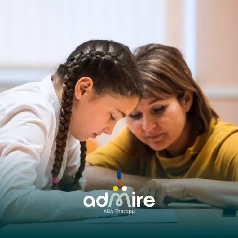 Autistic girl with braids focused on writing in a notebook while a supportive therapist watches over, helping her learn.