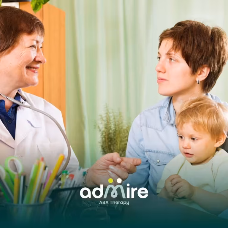 Therapist speaks with a parent & autistic child during a consultation, discussing developmental milestones