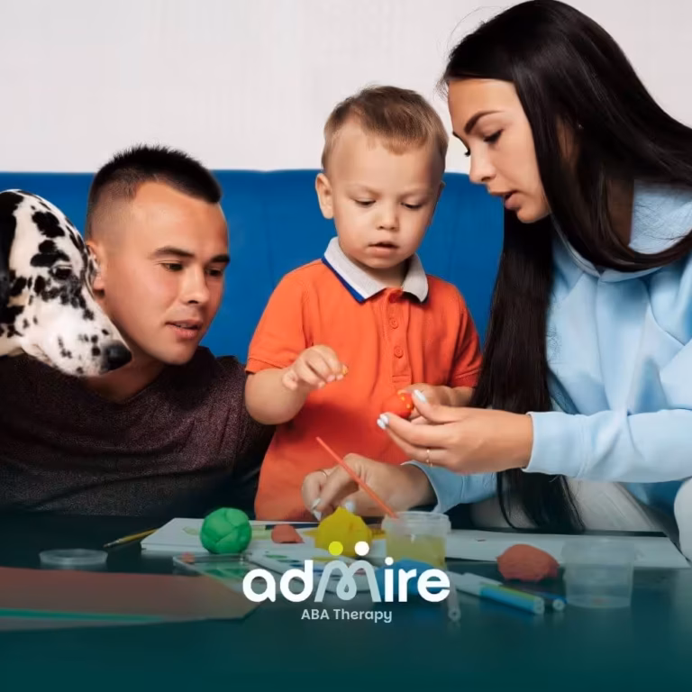 Therapists guide autistic boy in creative play at home with clay & paints, supporting early development & ABA skills