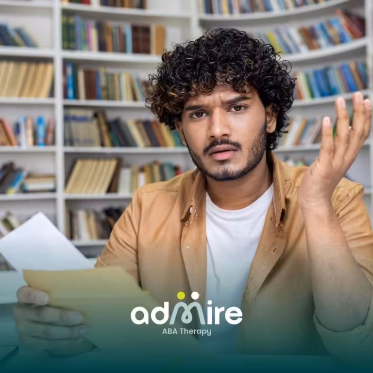 Confused ABA student sitting in a library looking at paperwork with raised hand, appearing frustrated.