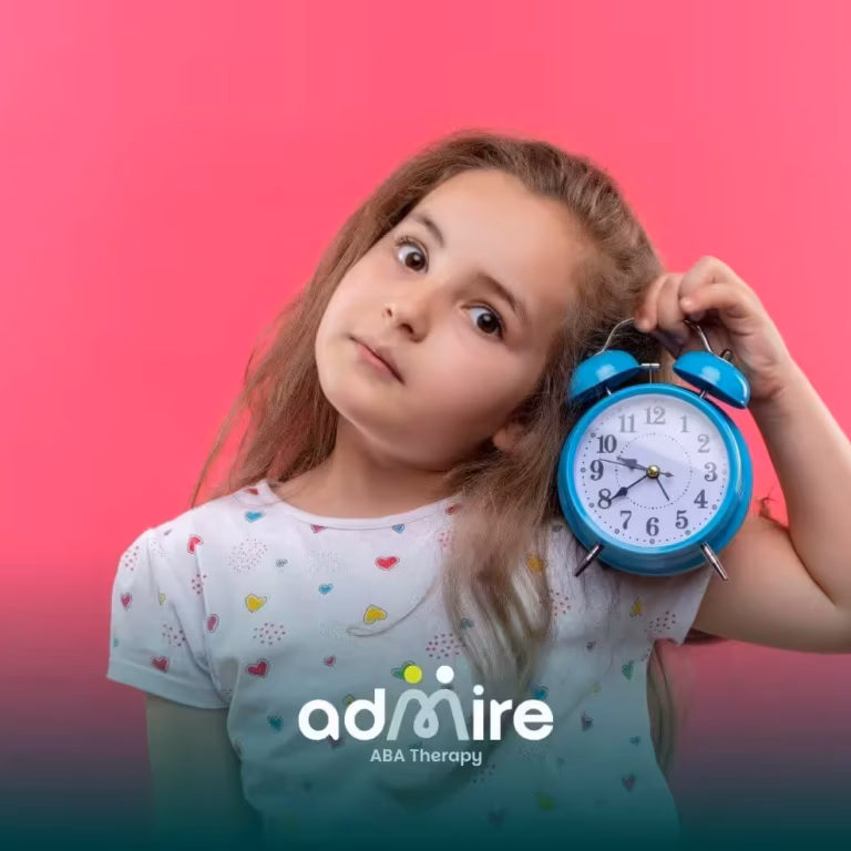An autistic girl holds a blue alarm clock against a bright pink background, showing curiosity about time and daily routines