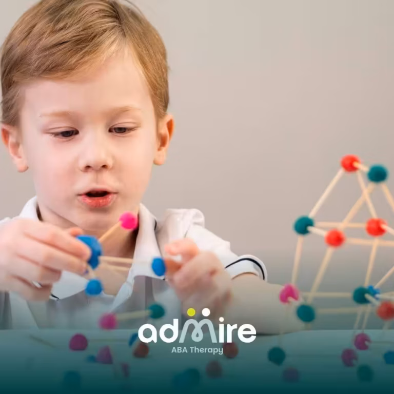 Autistic boy building colorful geometric structures with sticks and clay balls, developing problem-solving