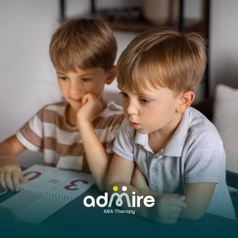  Two autistic kids sitting at a table with learning materials, representing cognitive development & early educational support.