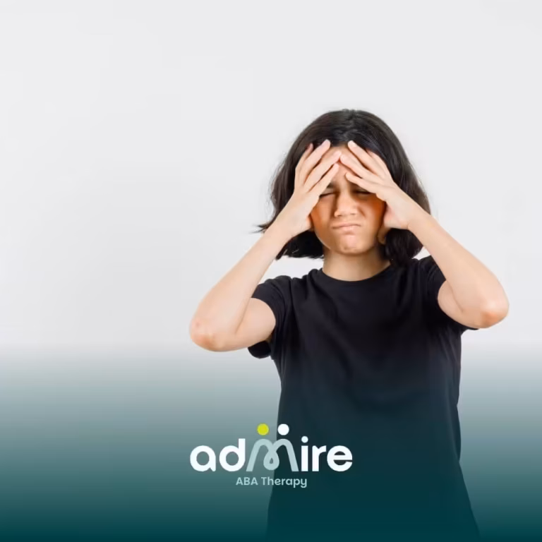 Autistic girl holding their head, illustrating challenges families may notice during developmental regression in autism.