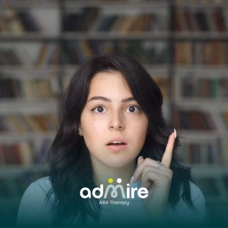 A Female therapist raises her index finger with a thoughtful expression, standing in front of a bookshelf background.