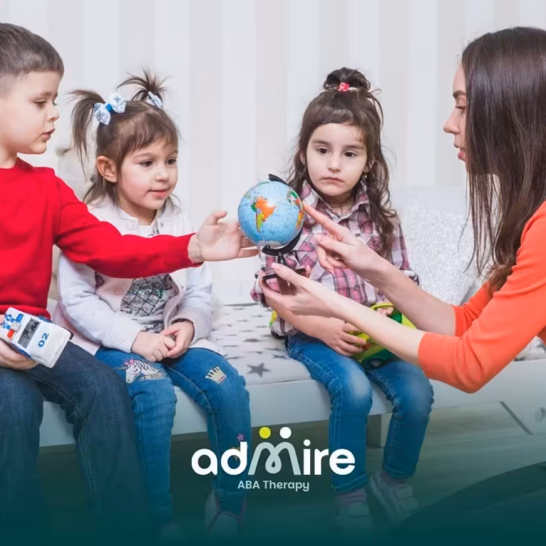 ABA therapist teaches autistic children using a globe and interactive learning tools during a group educational session
