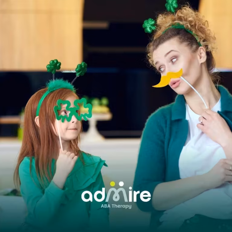Therapist & autistic girl wearing festive green outfits pose with playful props, smiling and bonding during ABA therapy