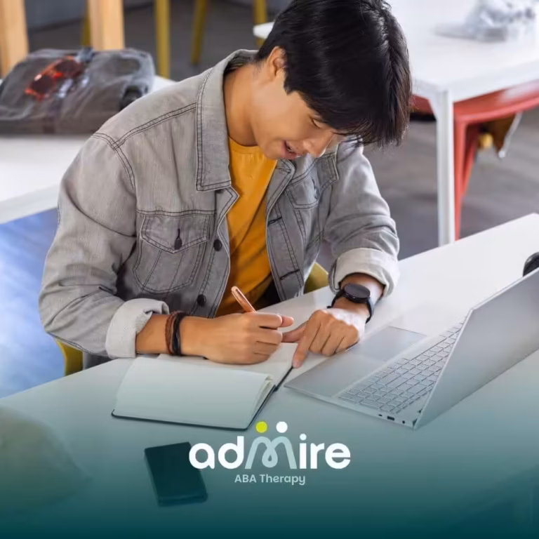 An ABA student writing notes beside laptop in classroom setting, illustrating use of study tools for preparing for the exam