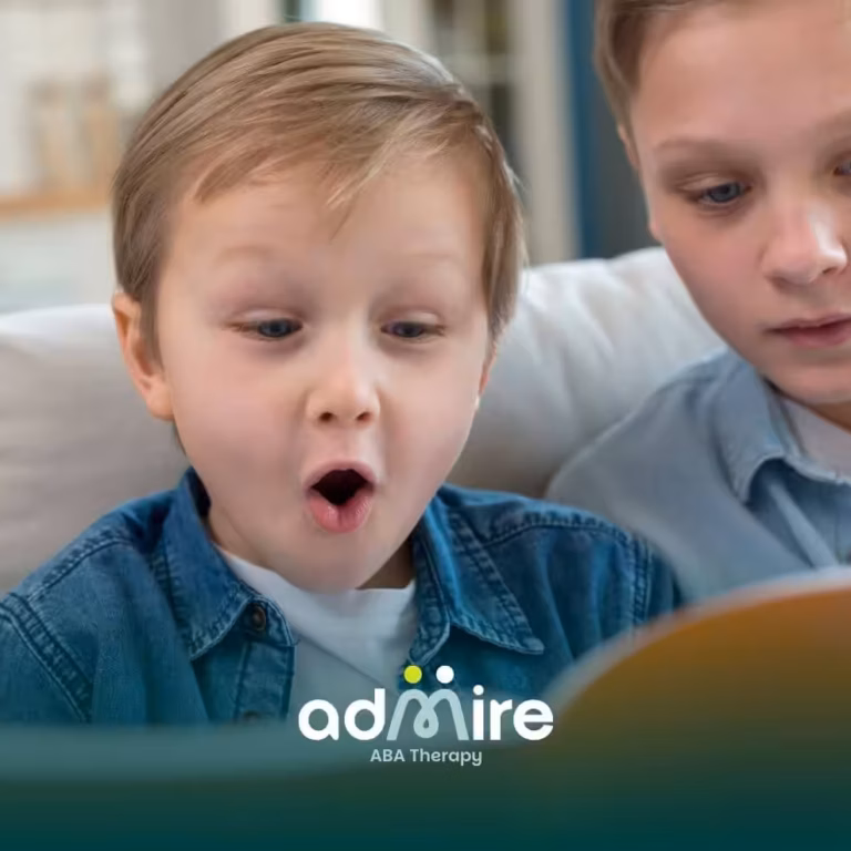 Two autistic kids reading together on a couch, highlighting early communication development and language-related milestones.