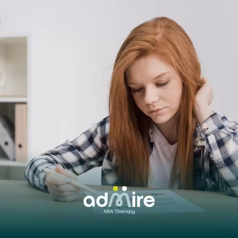 An autistic girl studying charts and graphs at a desk while feeling stressed or mentally overwhelmed at home